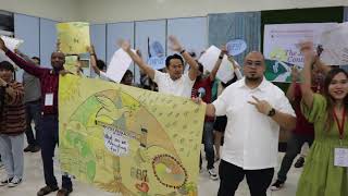 Participants holding a manila paper with an umbrella symbolizing the need for advocacy